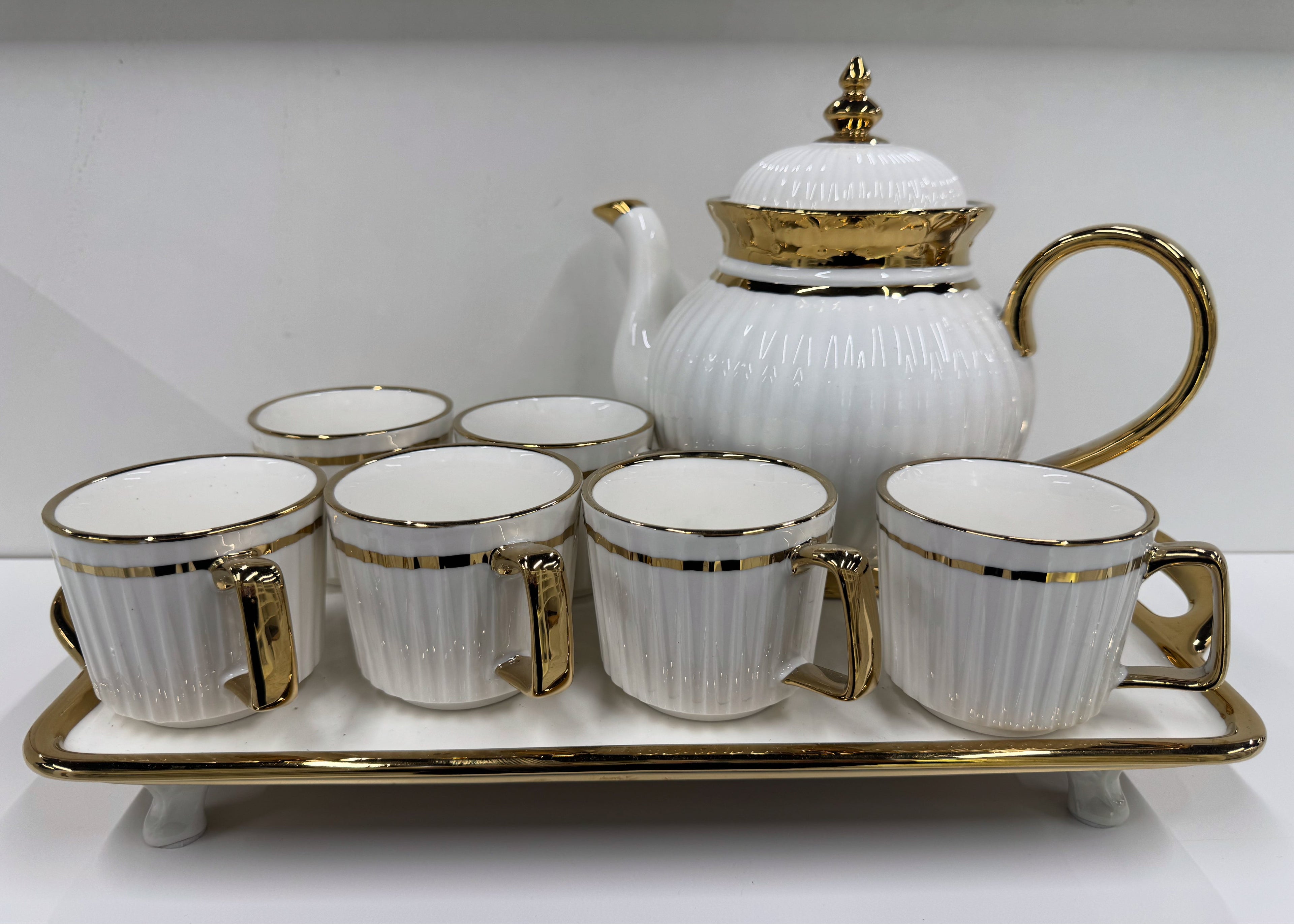 White teapot set with gold accents