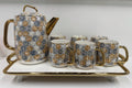 Ceramic tea set with hexagonal pattern on a white surface