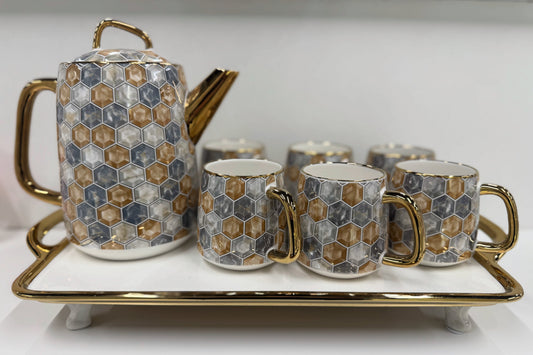 Ceramic tea set with hexagonal pattern on a white surface