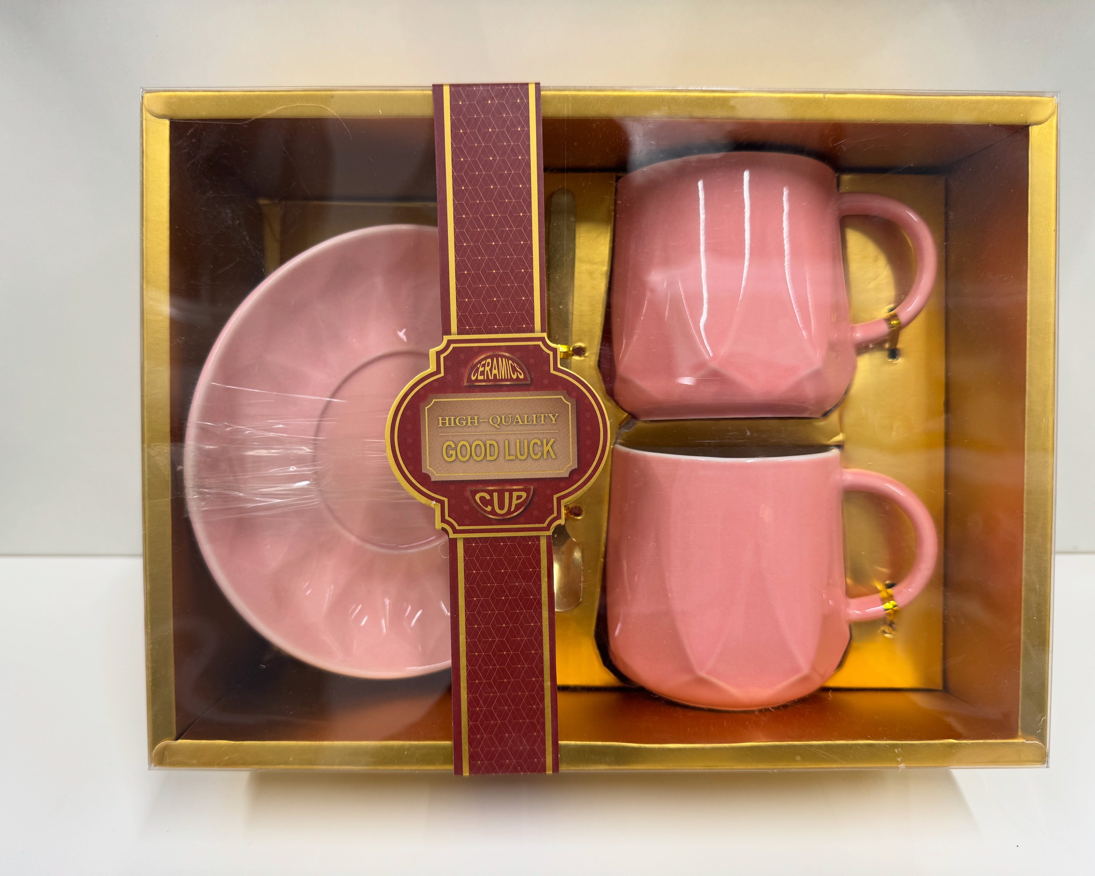 Two pink cups with 2 spoons